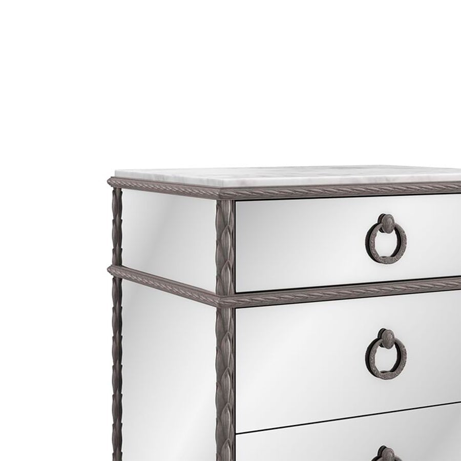 Close-up of mirrored nightstand with intricate details.
