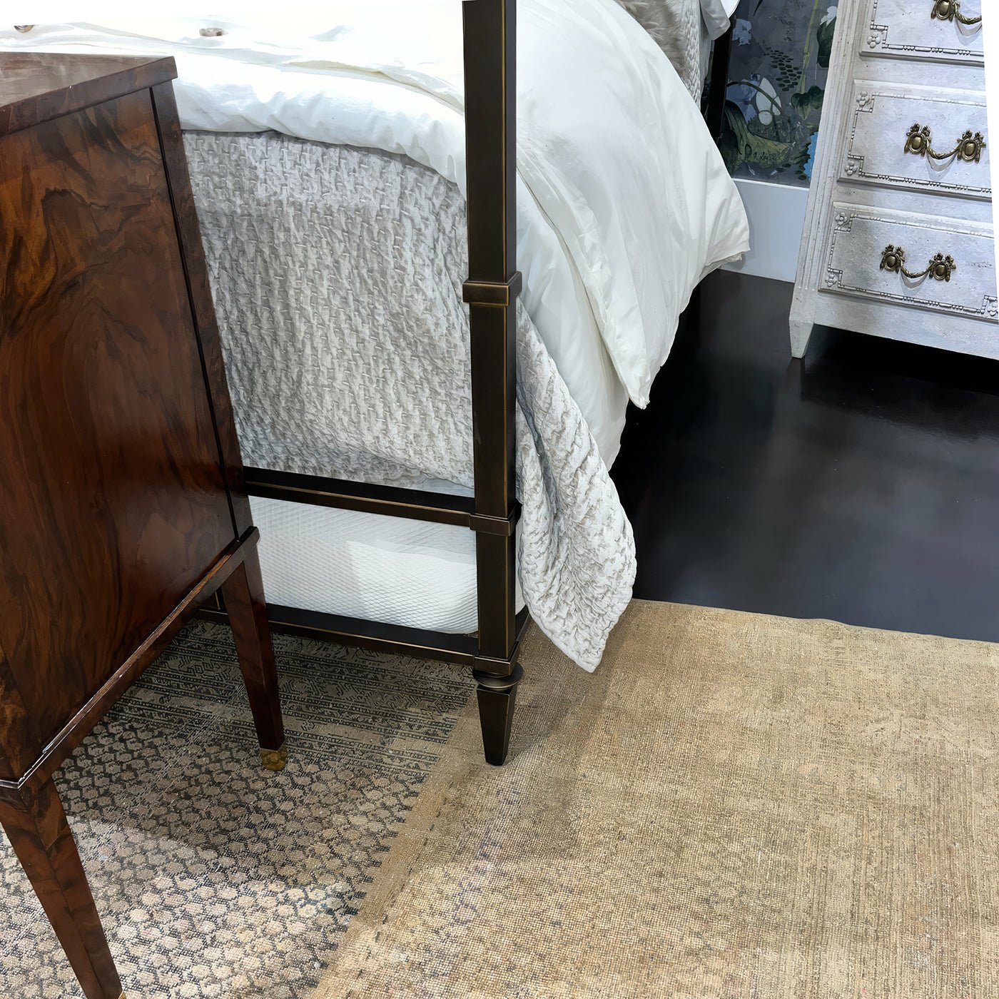French metal canopy bed footboard and corner detail in room.