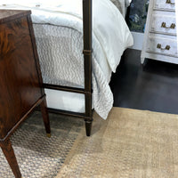 French metal canopy bed footboard and corner detail in room.