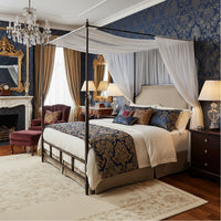 Luxurious bedroom with French metal canopy bed, dressed.