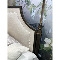 Close-up of French metal canopy bed headboard and post.