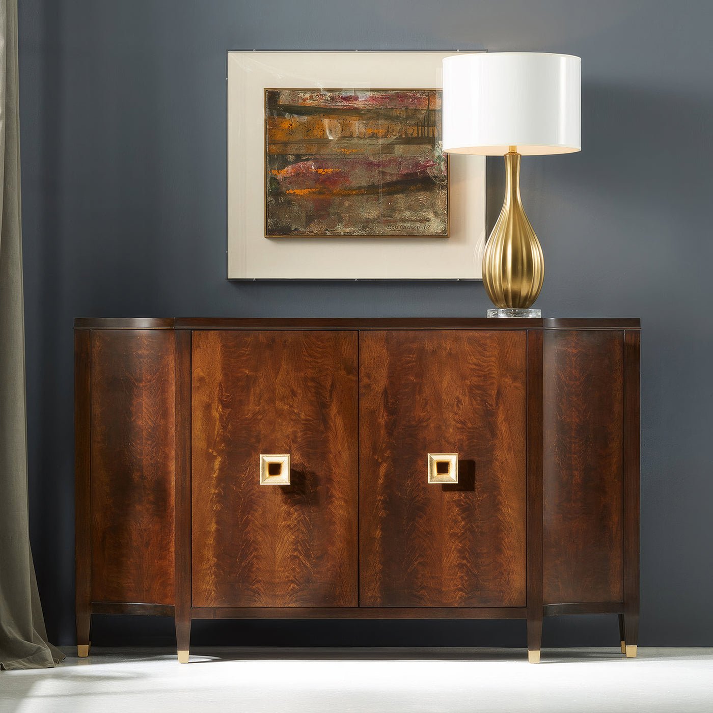 Stylish sideboard with lamp and painting, elegant setting.