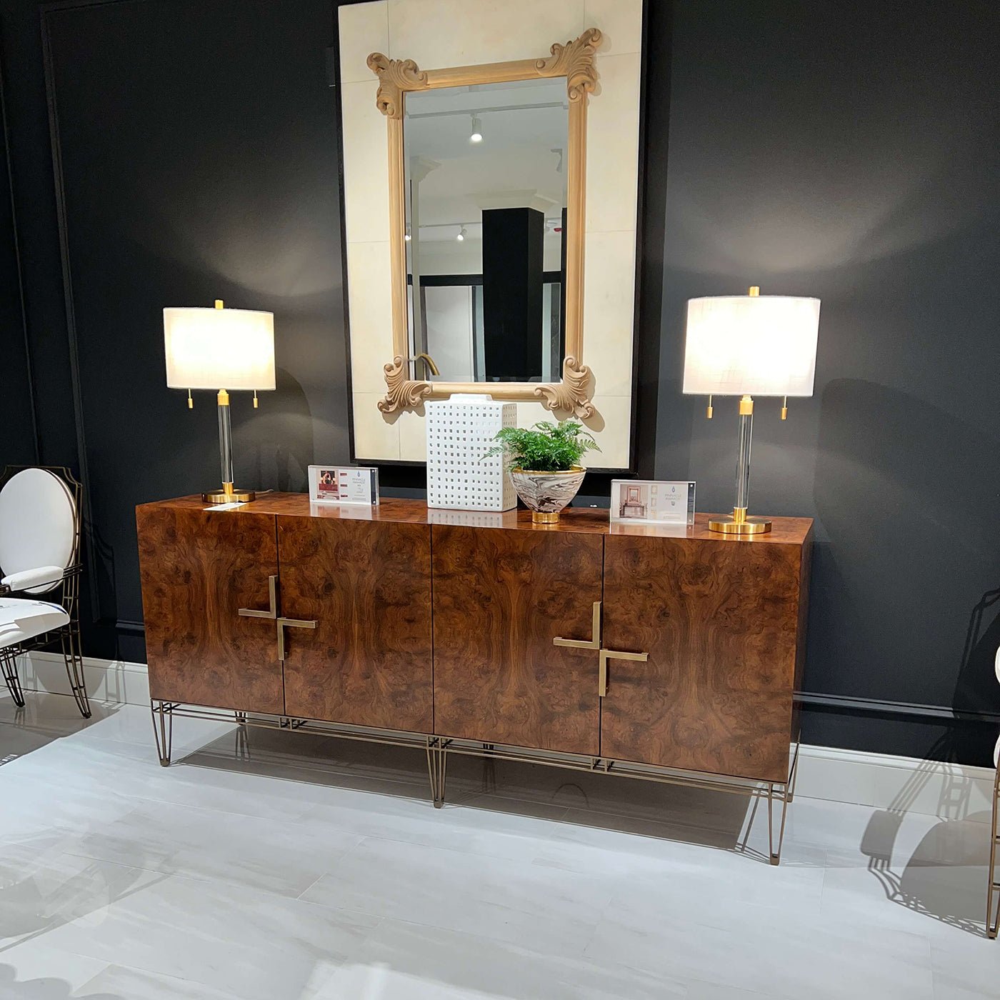 Sideboard against dark wall with decorative items.