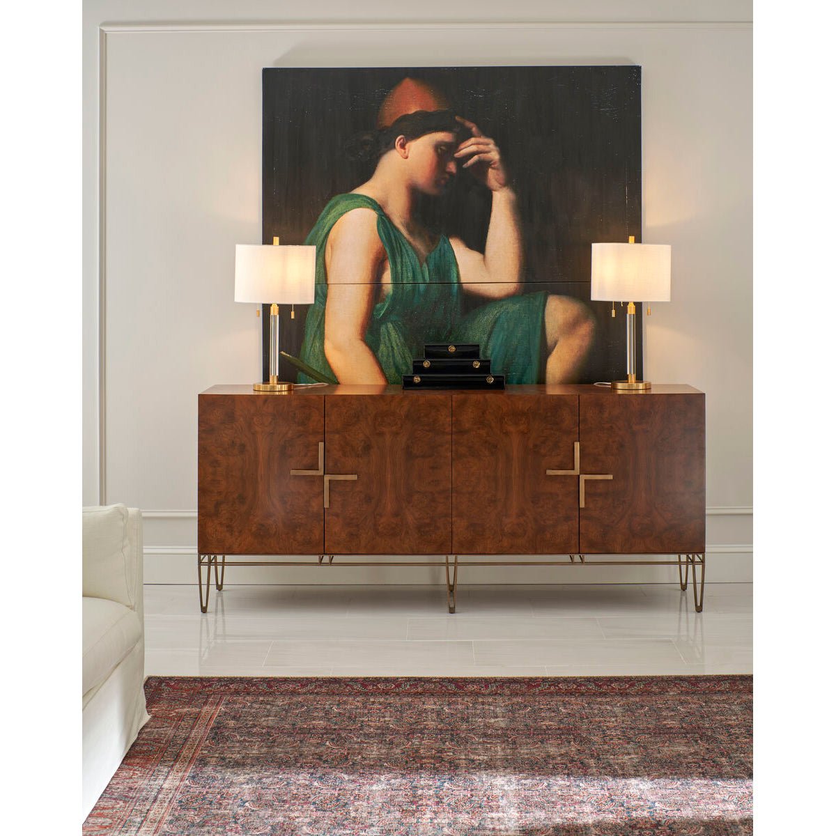 Modern sideboard in living room with artwork and lamps.