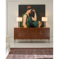 Modern sideboard in living room with artwork and lamps.