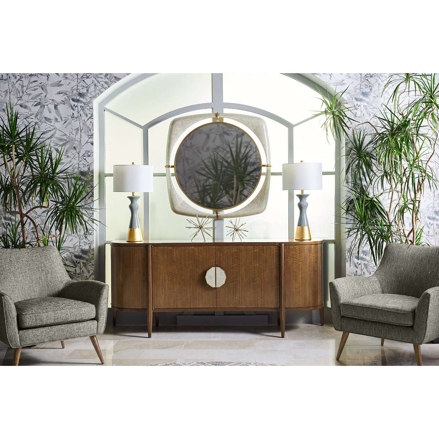 Mirror on wall with wooden cabinet, plants, gray chairs.