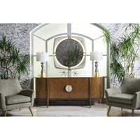 Mirror on wall with wooden cabinet, plants, gray chairs.