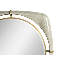 Close-up of mirror's top corner with gold elements.