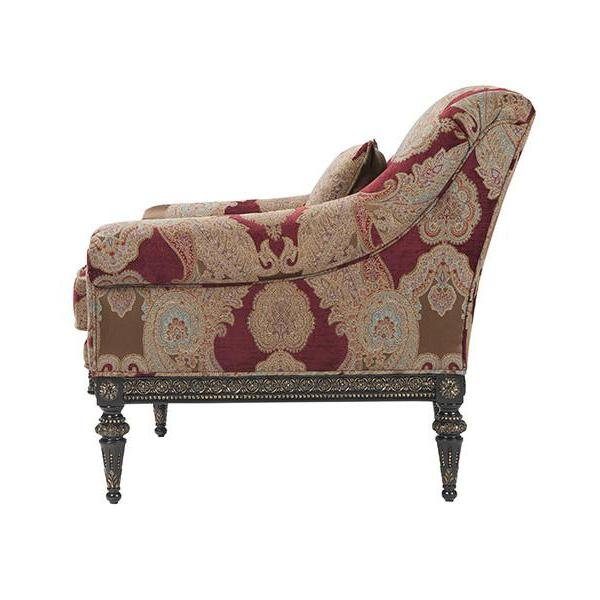 Red floral patterned armchair, side view.