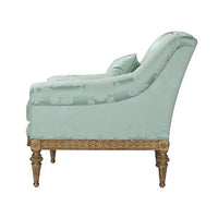 Patterned light green armchair, side view.