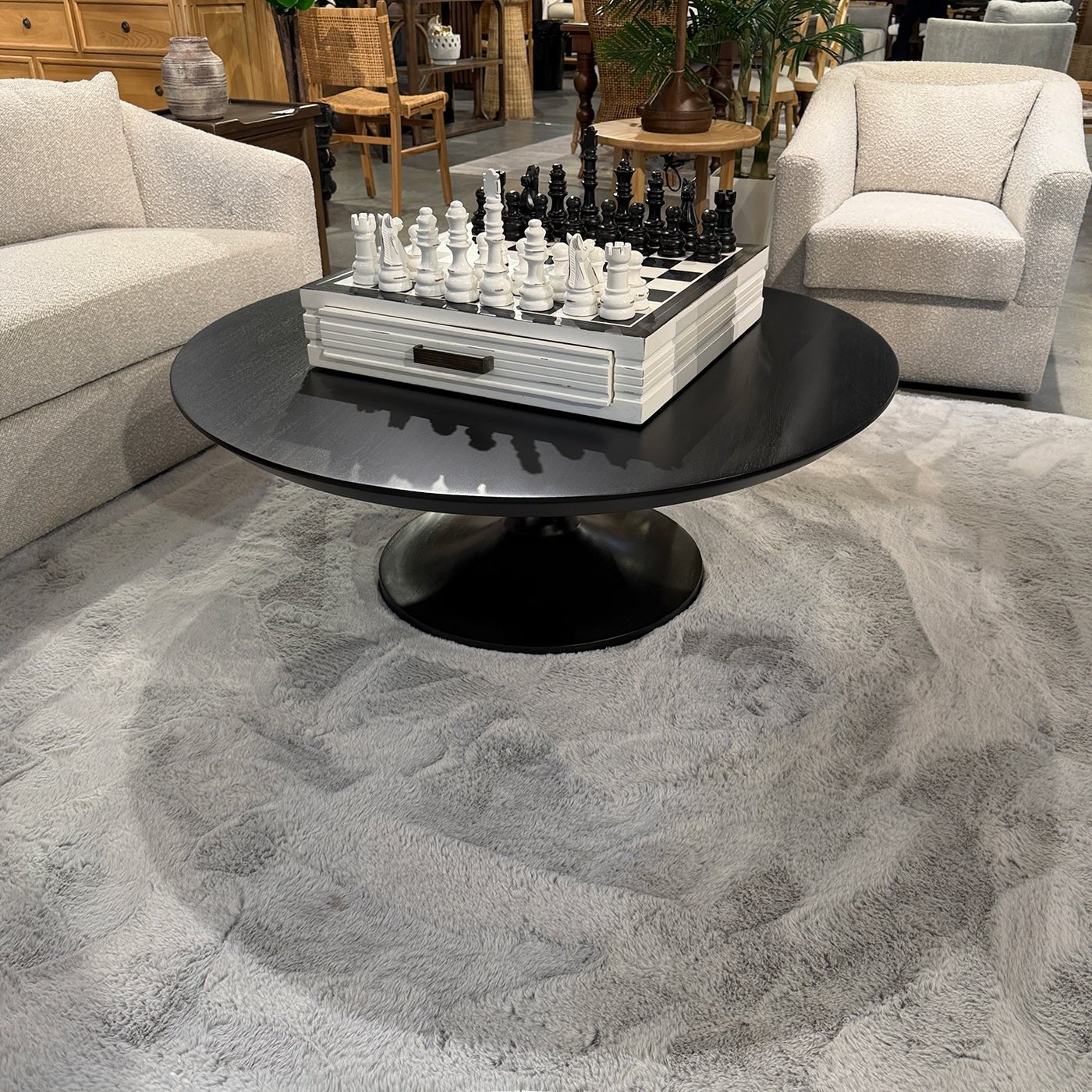 Tulip coffee table with chess set in cozy setting.