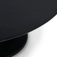 Side angle of sleek black tulip coffee table.