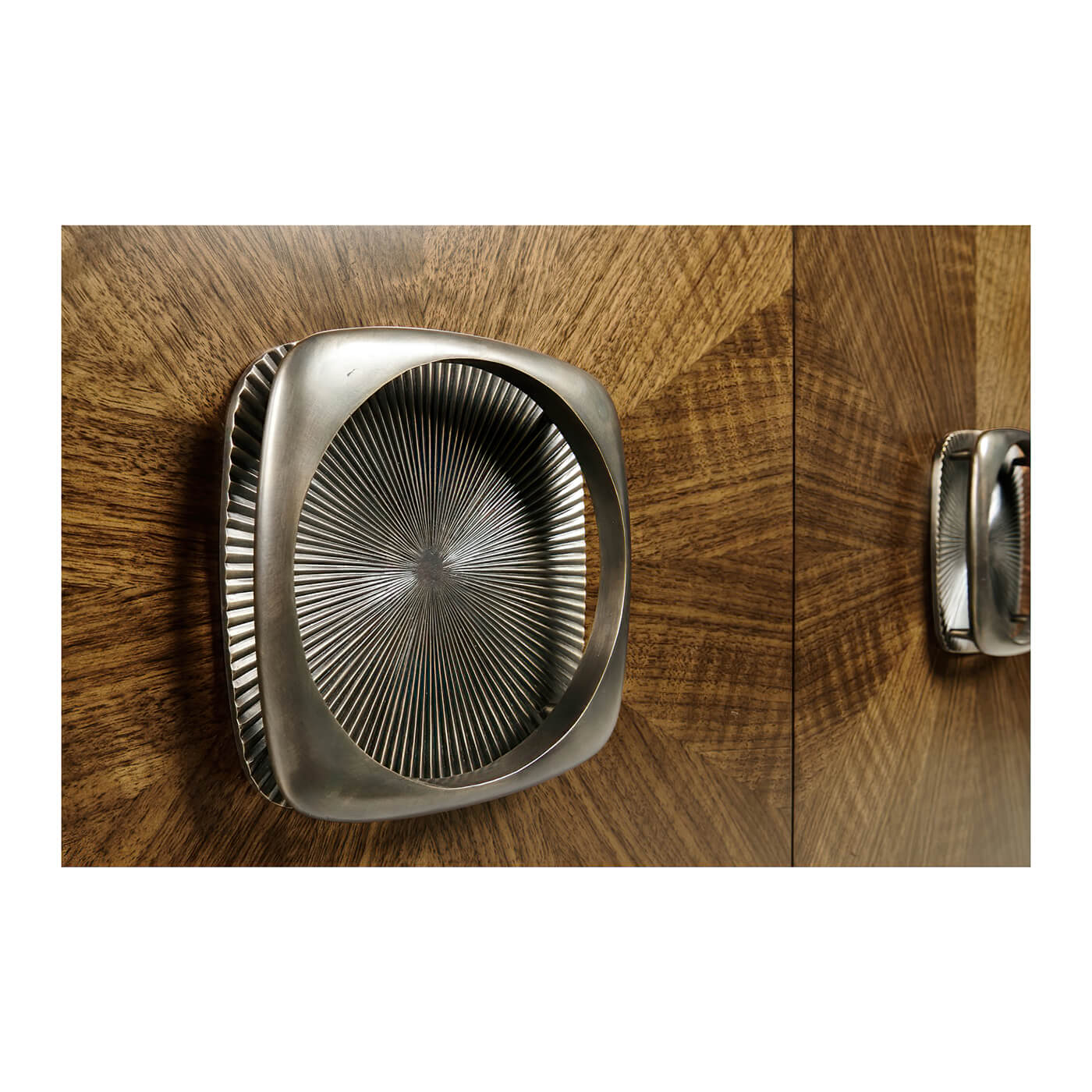 Close-up of cabinet handle with textured, metallic design.