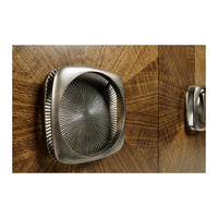 Close-up of cabinet handle with textured, metallic design.