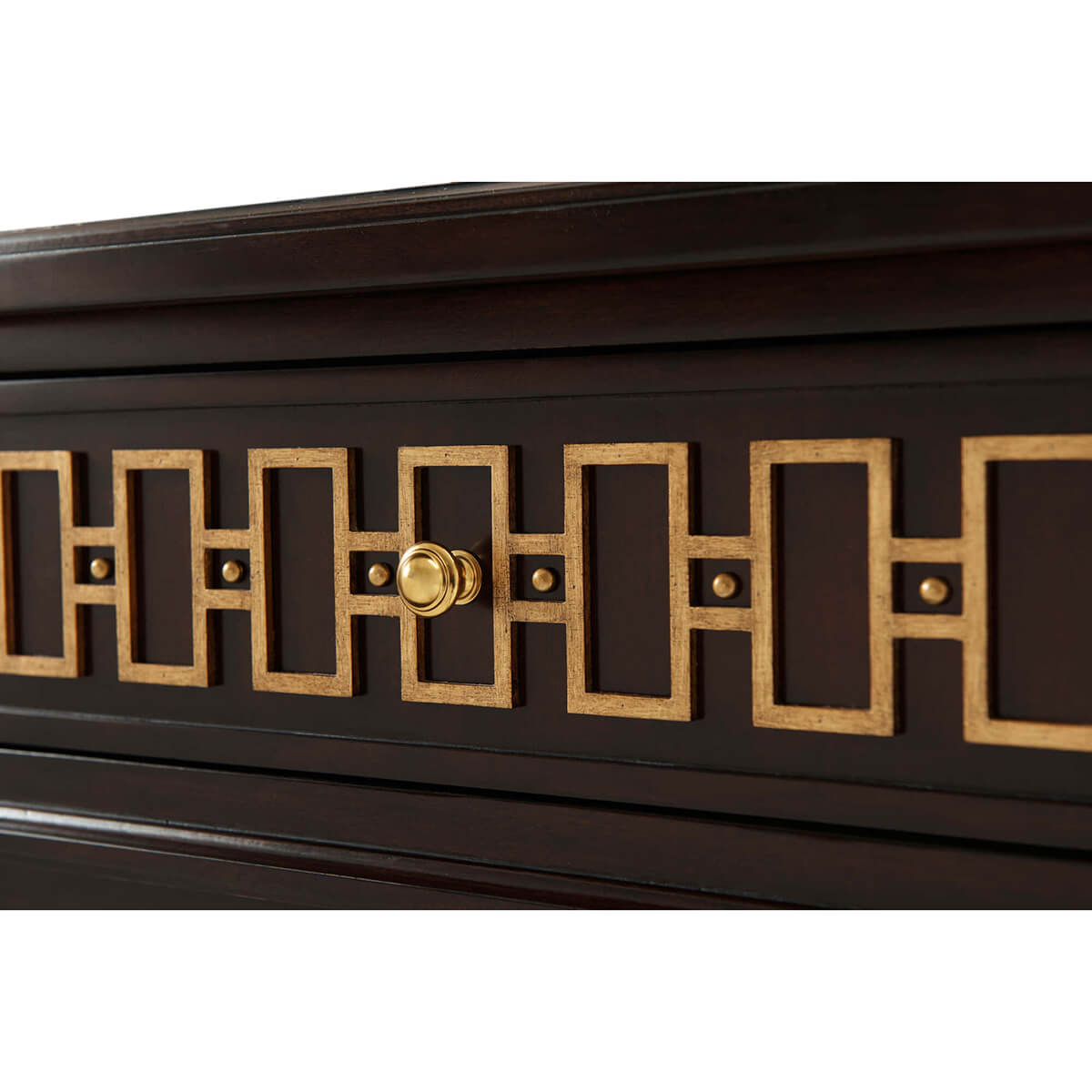 Close-up of gold geometric design on dresser.