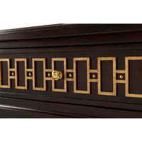 Close-up of gold geometric design on dresser.