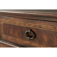 Close-up of French Neoclassic dresser drawer handle detail.