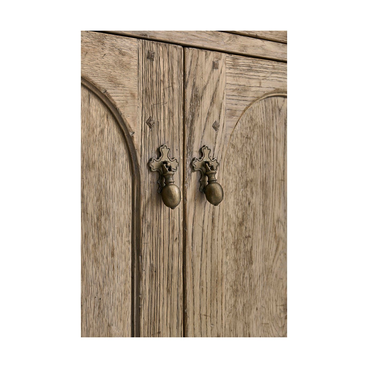Detail of sideboard door handles and wood texture.