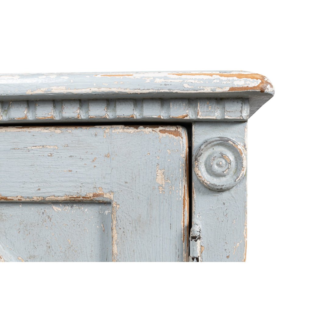 Close-up of corner detail on blue sideboard.