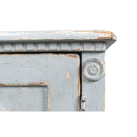 Close-up of corner detail on blue sideboard.