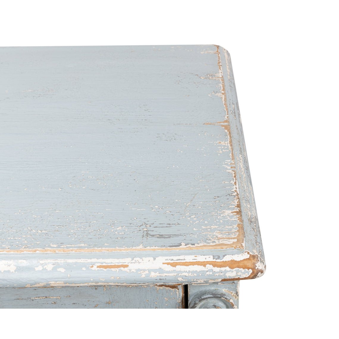 Close-up of distressed corner on blue sideboard.