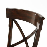 Close-up of French Provincial chair backrest x-design detail.
