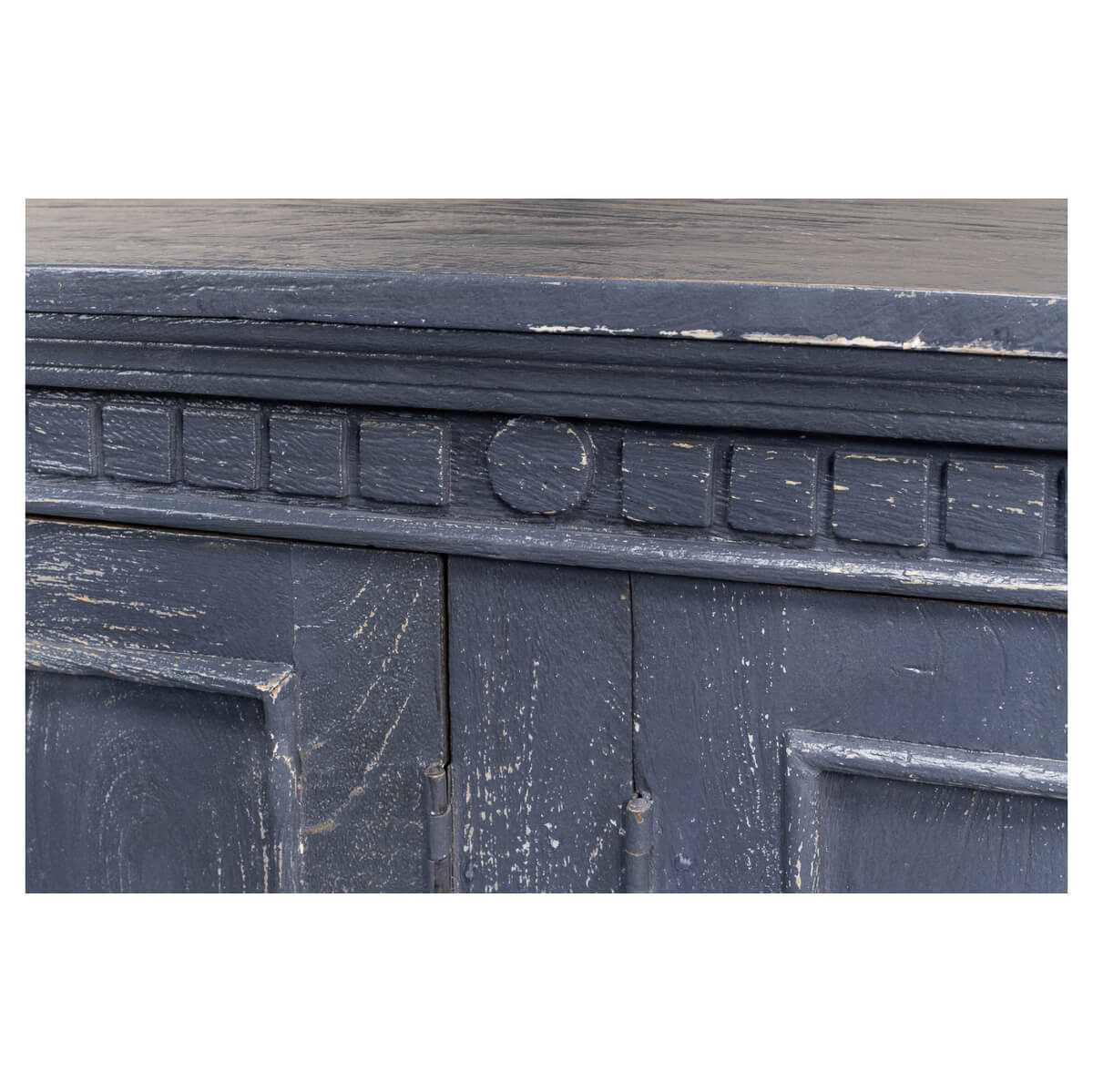 Close-up of ornate trim above doors on credenza.
