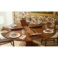 Side view of extended dining table with floral backdrop.