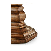 Close-up view of round dining table's pedestal design.