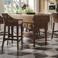 Close-up of kitchen island with chairs and decor.