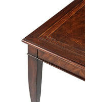Close-up of dining table corner, showing wood texture.