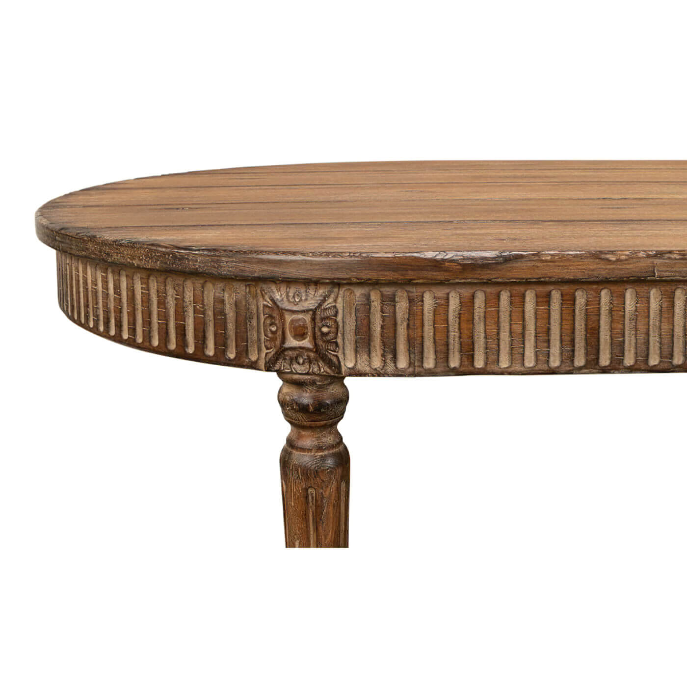 Close-up of carved details on oval dining table edge.