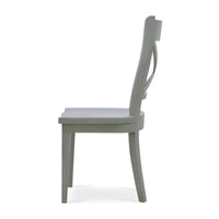 Wooden dining chair with X-back design, side view.