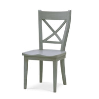 Wooden dining chair with X-back design, angled view.