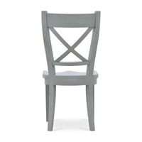 Wooden dining chair with X-back design, rear view.