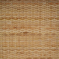 Close-up of wicker texture on French Provincial cabinet drawer.