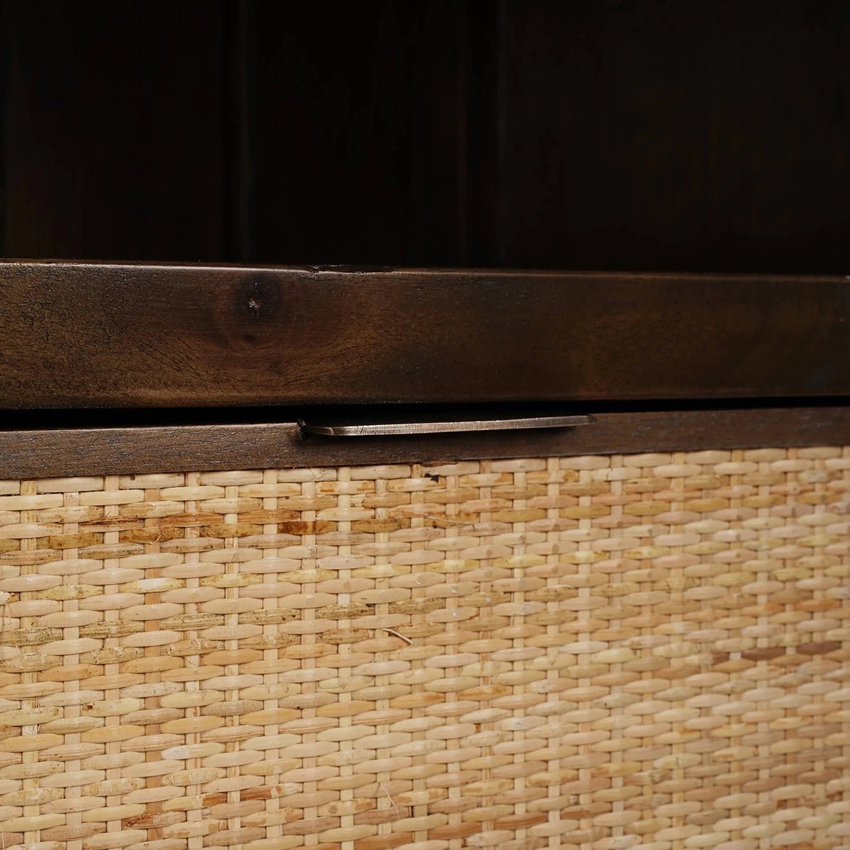Close-up of wicker drawer under shelf.