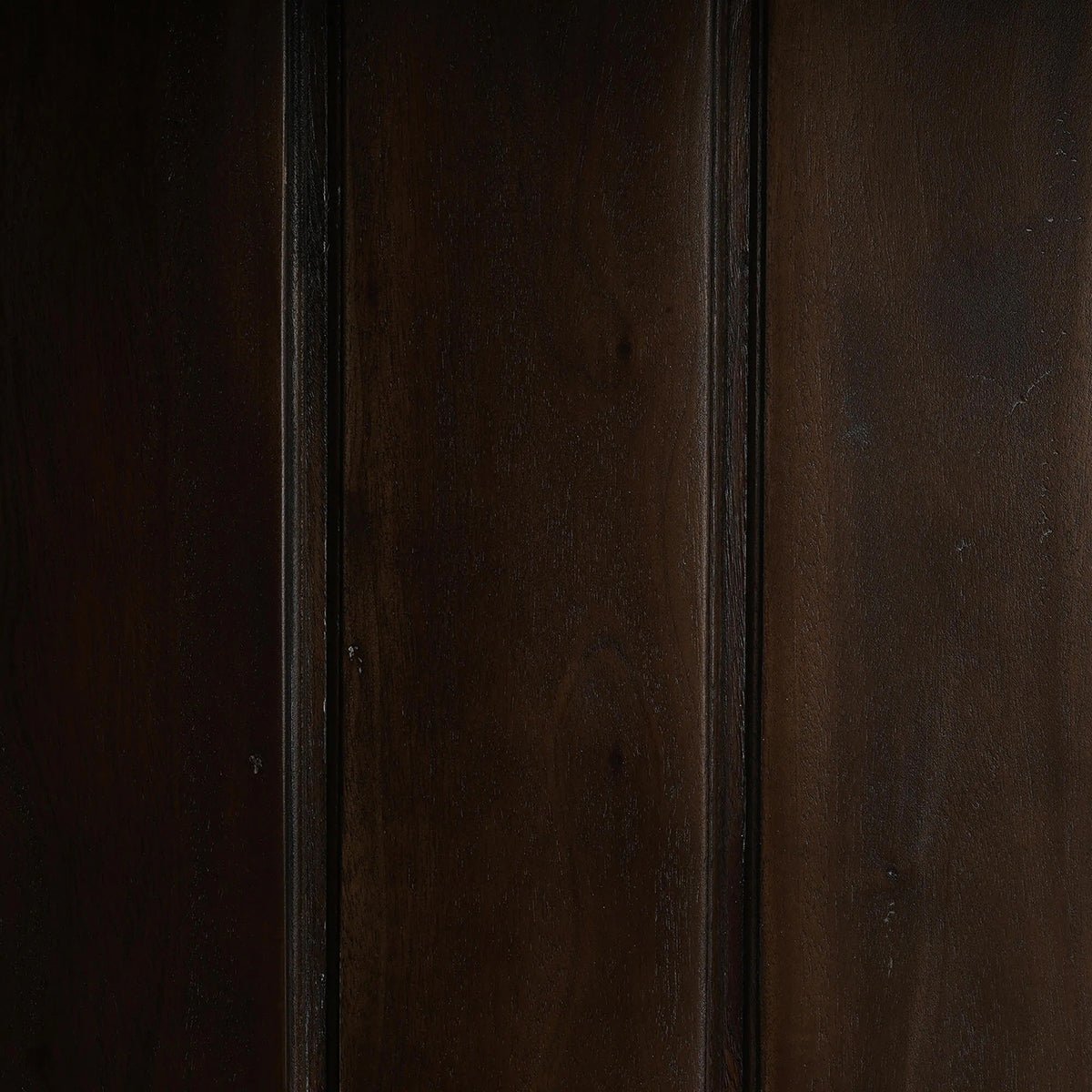 Dark wood interior panel of display cabinet.