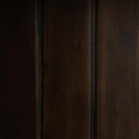Dark wood interior panel of display cabinet.