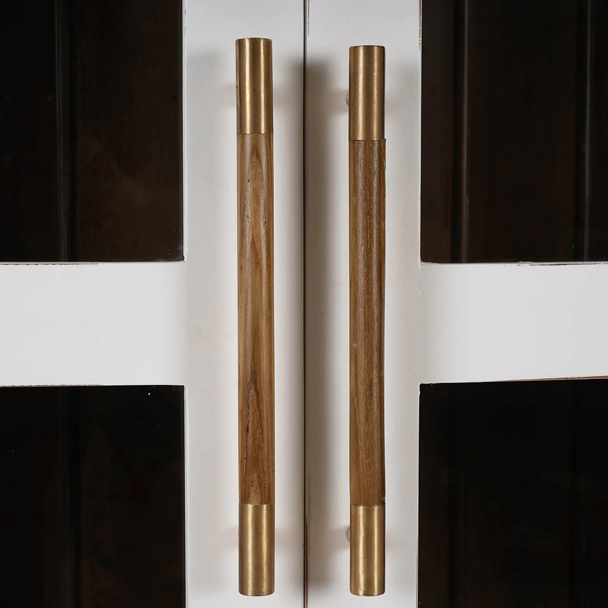 Close-up of cabinet's wooden and brass handles.
