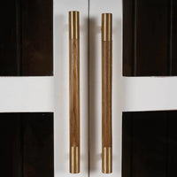 Close-up of cabinet's wooden and brass handles.