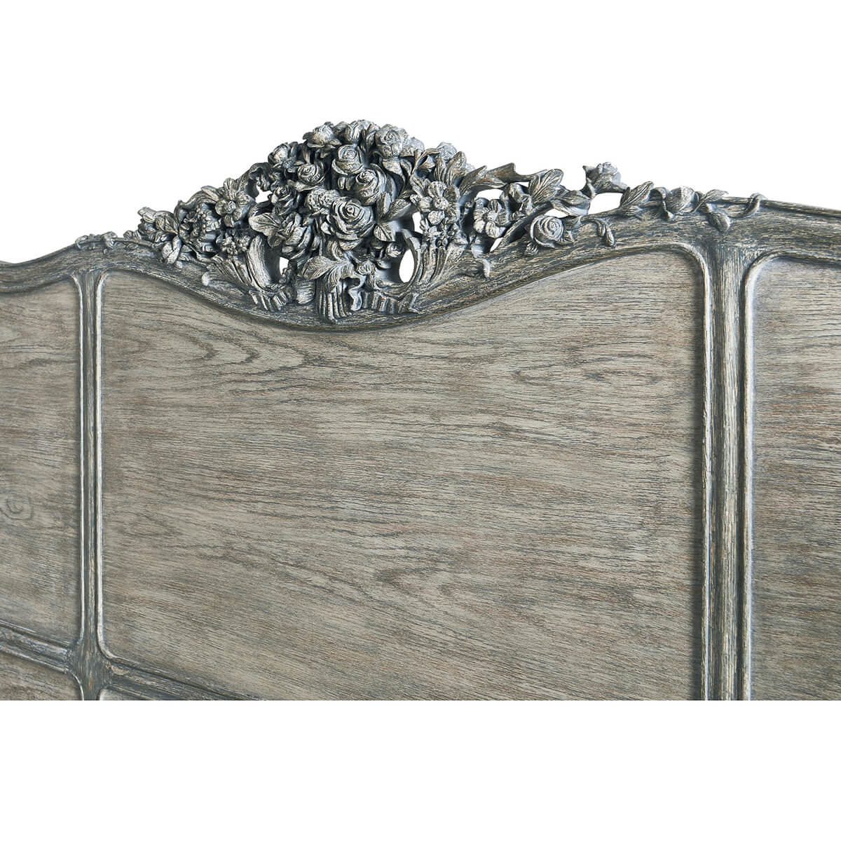 Detailed floral carving on French Provincial headboard.