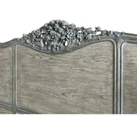 Detailed floral carving on French Provincial headboard.