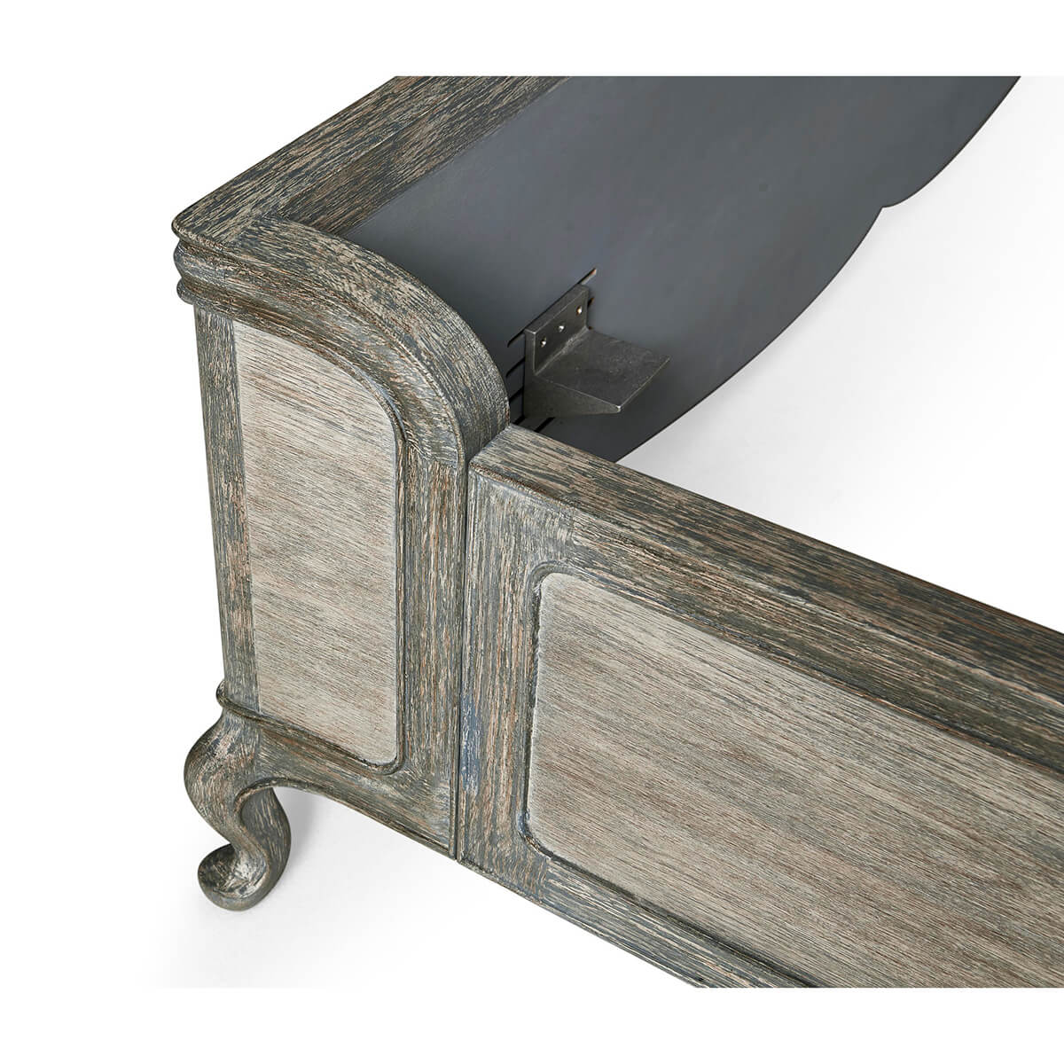 Corner detail of bed frame with metal fixture.