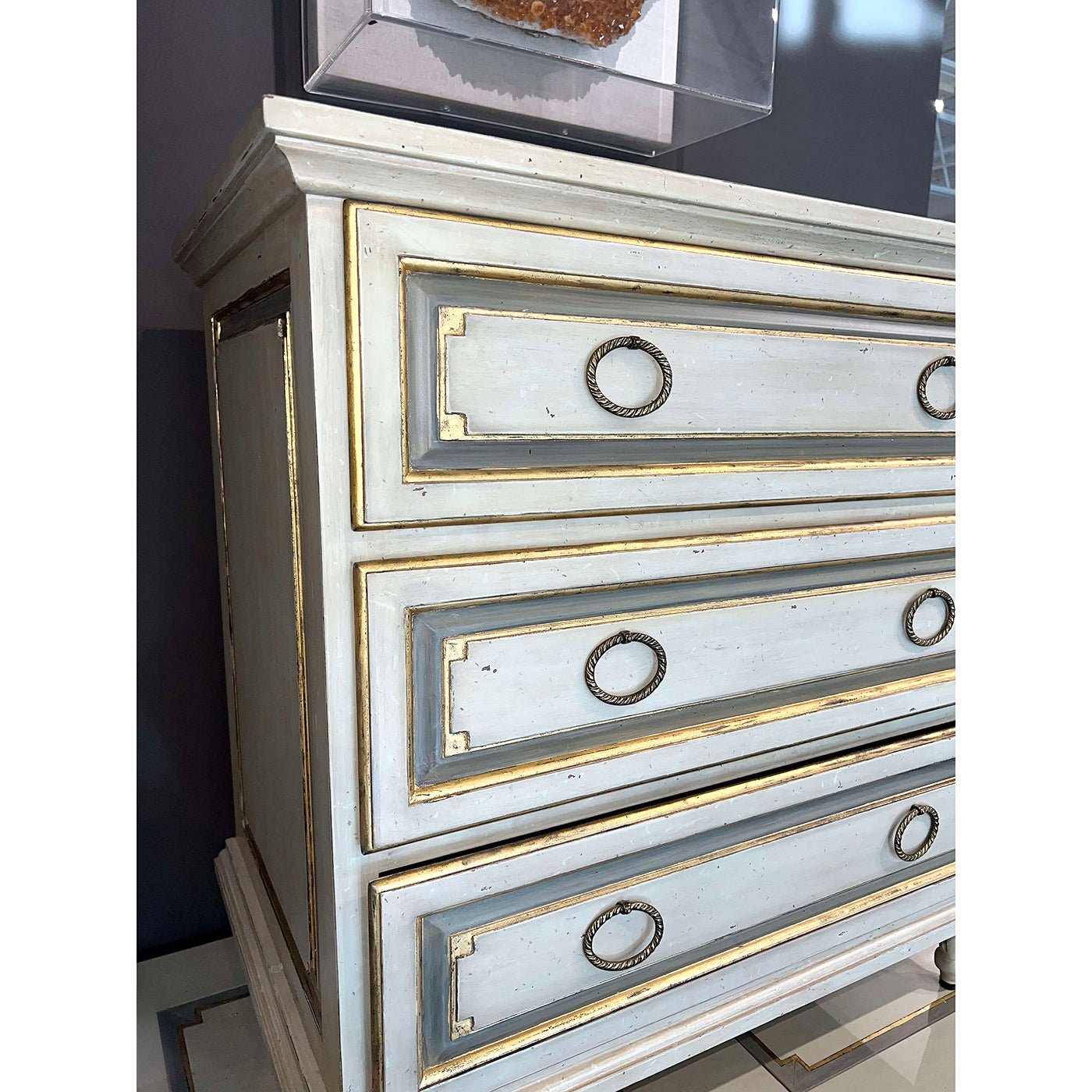 Close-up of nightstand drawer handles, French Provincial design.