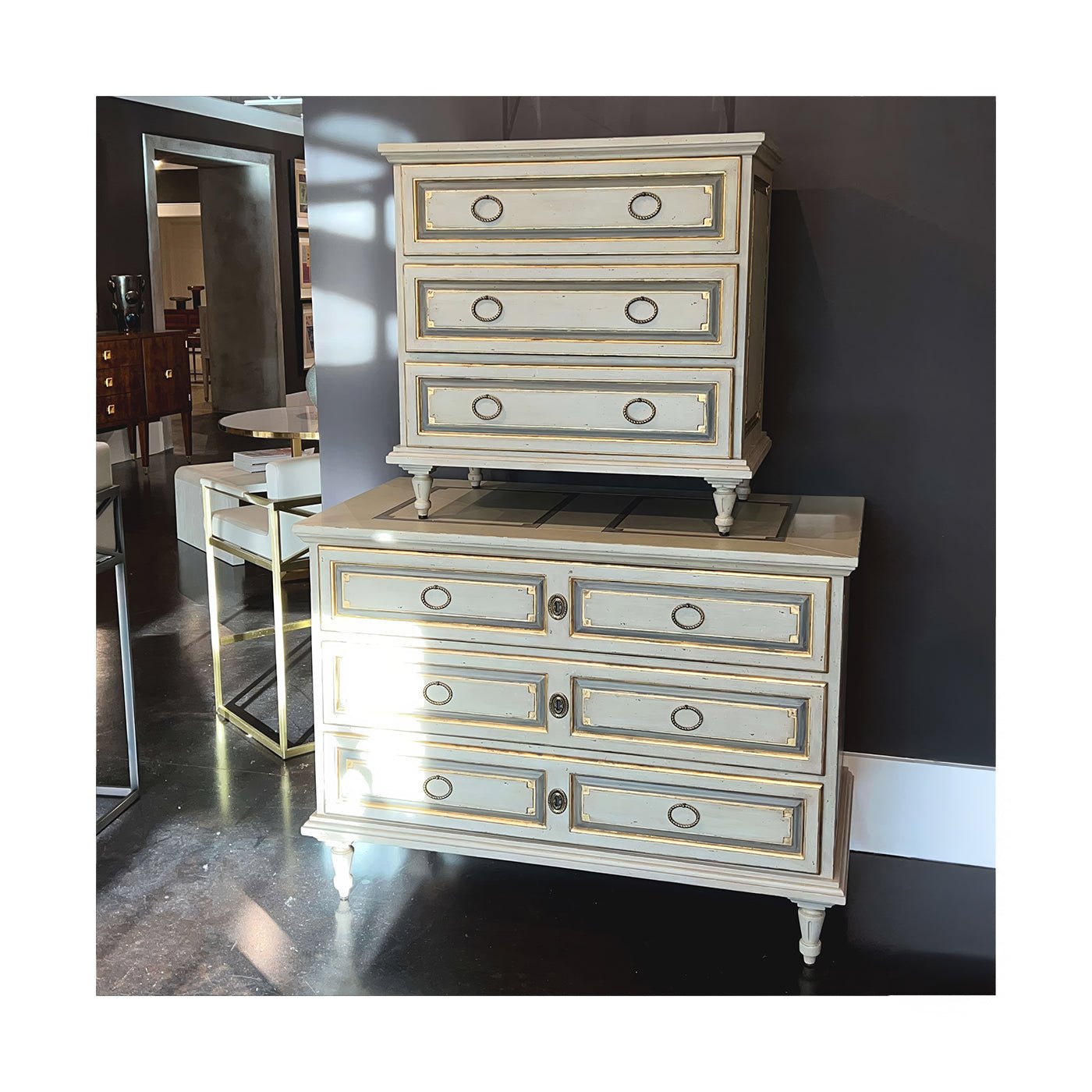 Two French Provincial nightstands in modern showroom.