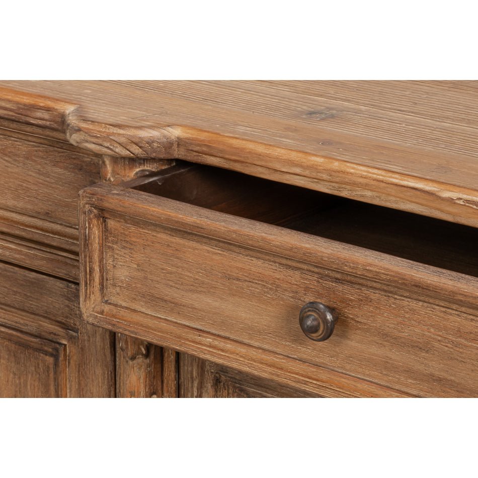 Sideboard drawer partially open, knob visible.