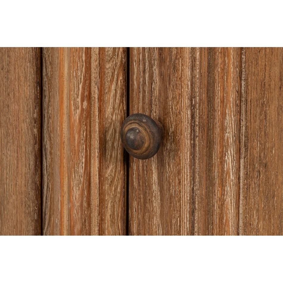 Close-up of sideboard cabinet knob detail.