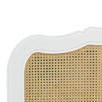 Close-up of French Provincial bed's wicker headboard.