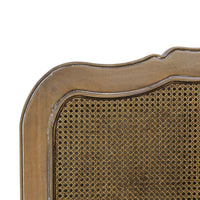 Close-up of French provincial bed, detailed straw weave.